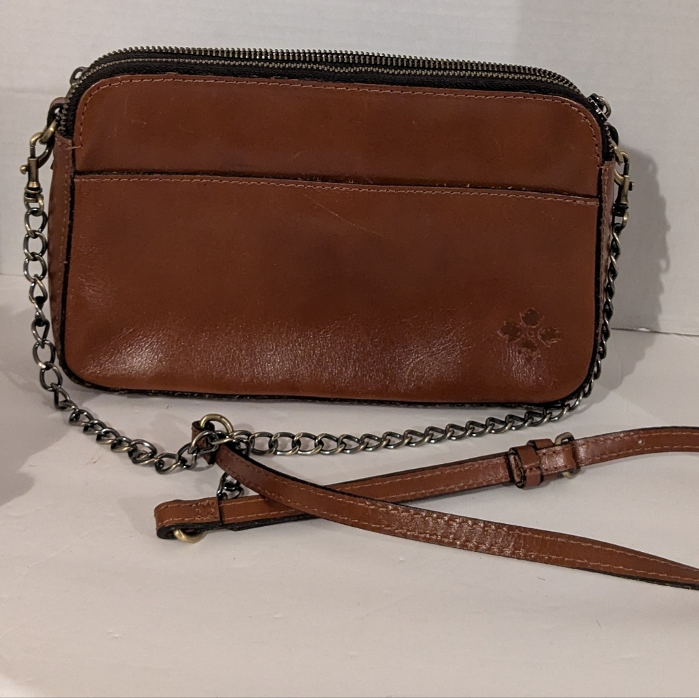 Patricia Nash brown leather crossbody bag with a chain strap. 